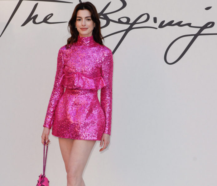 Anne Hathaway poses at Photocall of Valentino fashion show in July 2022